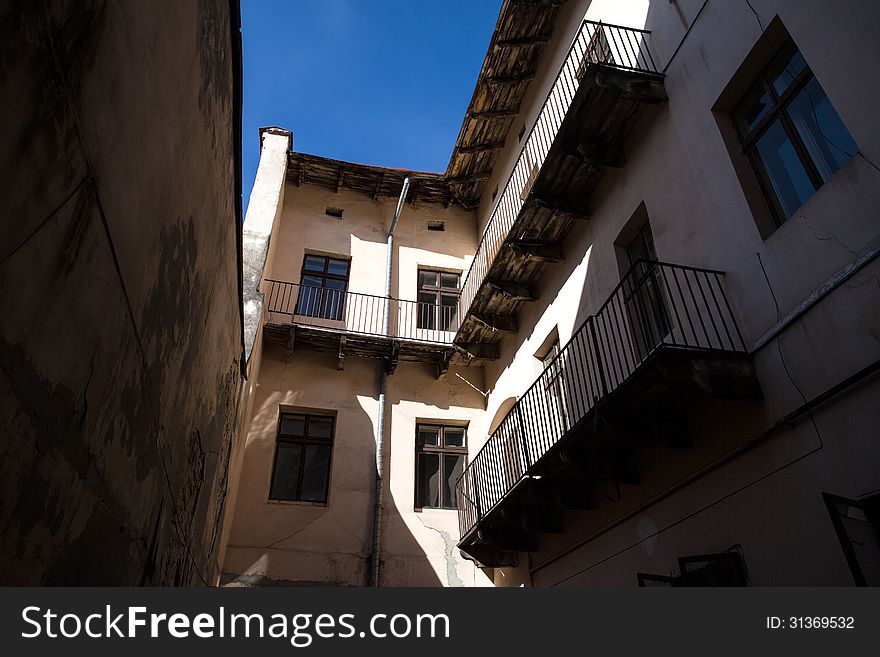 Illuminated by sun wall of the old house, the view from the courtyard. Lviv, Ukraine