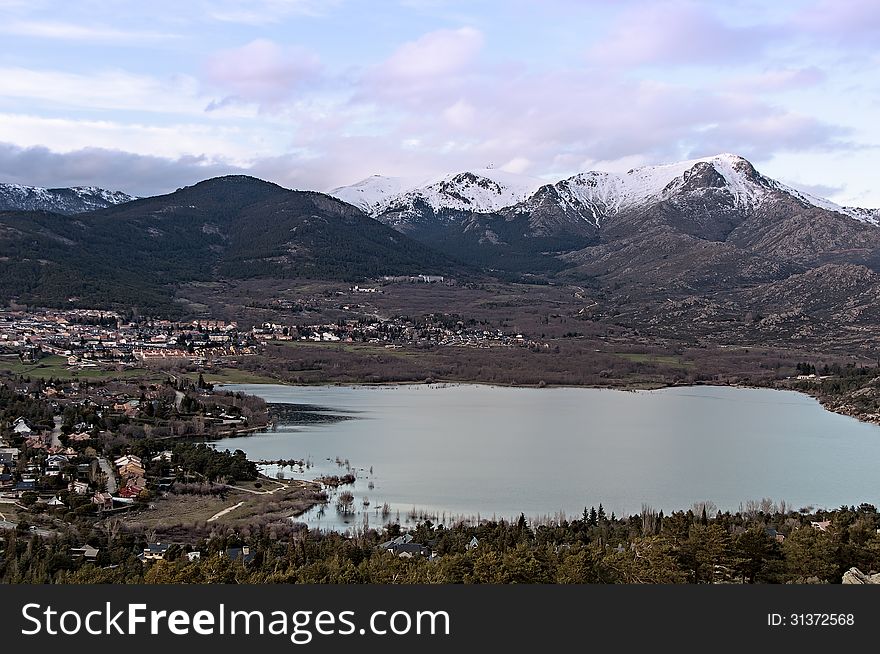 Views Of The Town And Lake With Snowy Mountains