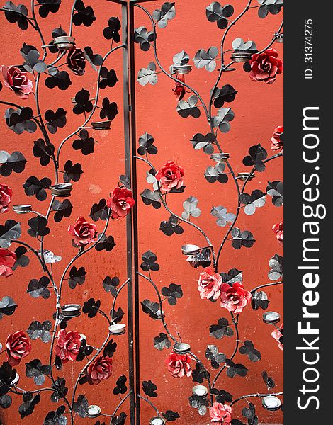 Iron Screen Partition with red flowers and candles holders.