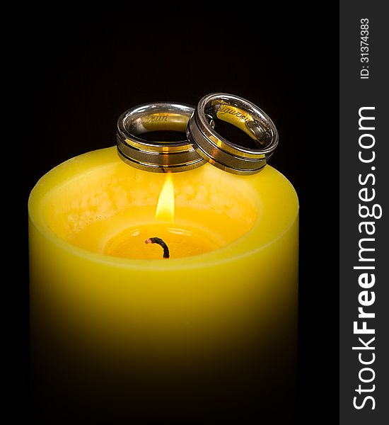 Wedding rings on a candle