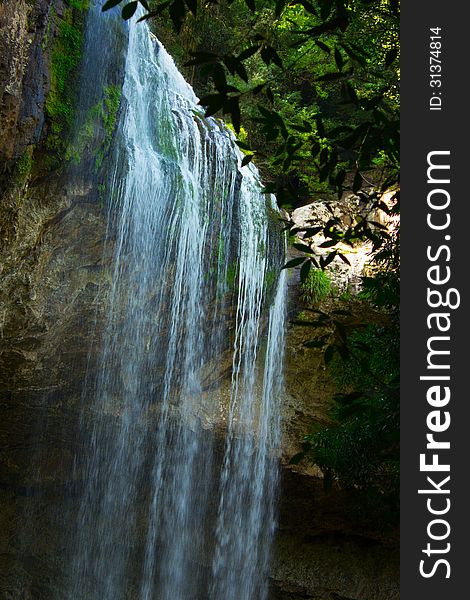 Detail of cascade waterfall in green area preserved