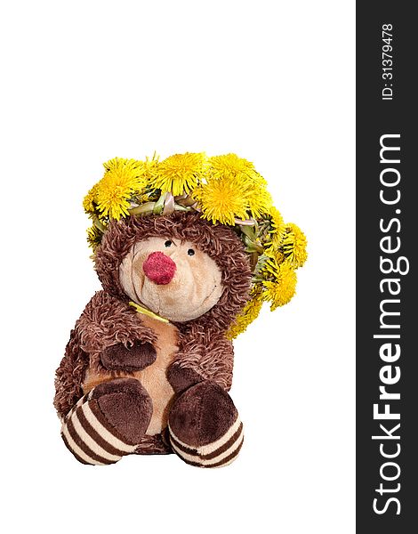 Toy hedgehog in a wreath of dandelions