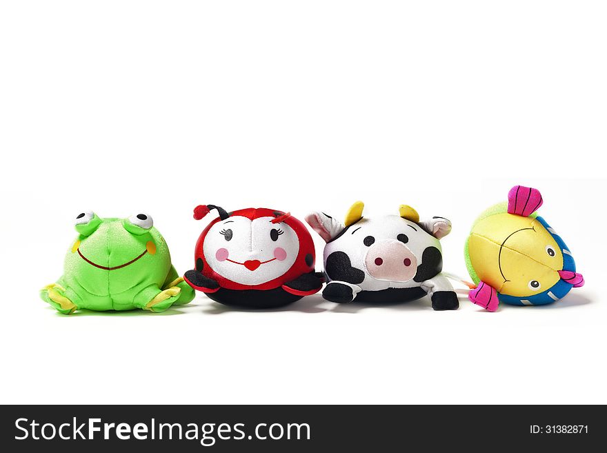Toy frog, ladybug, cow and fish sit in a row. Toy frog, ladybug, cow and fish sit in a row.