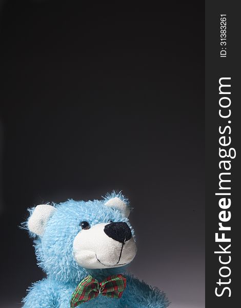 A blue bear stares up in a thoughtful happy way. A blue bear stares up in a thoughtful happy way.