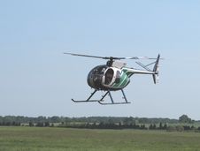Helicopter Flying Low Over The Ground. Stock Images