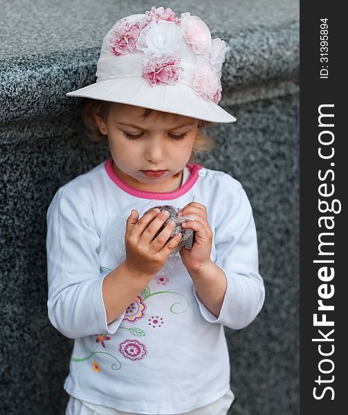 Portrait of the girl against a granite wall. Portrait of the girl against a granite wall.