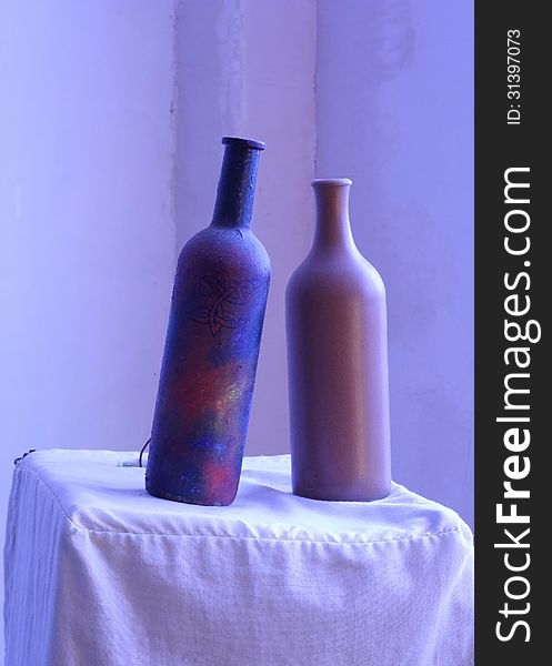 Two clay bottle peacefully standing on the table