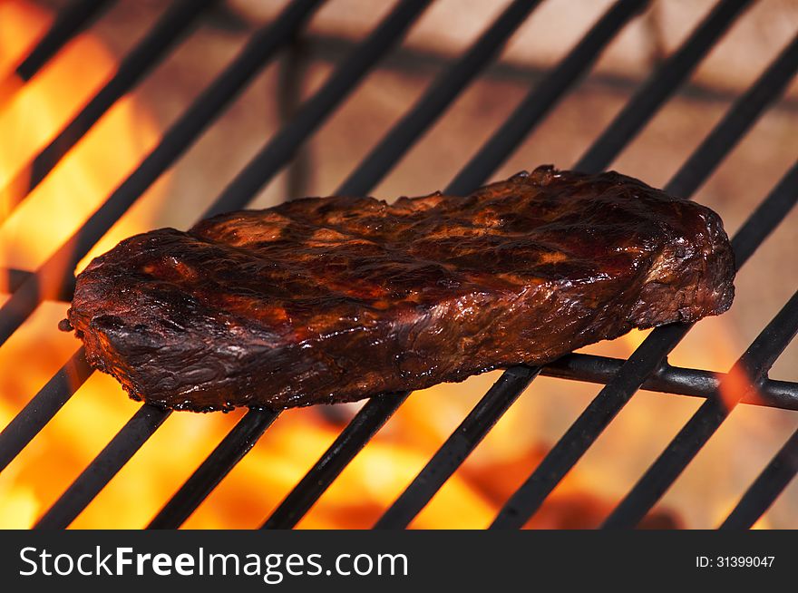 Sirloin steak on grill with flames. Sirloin steak on grill with flames