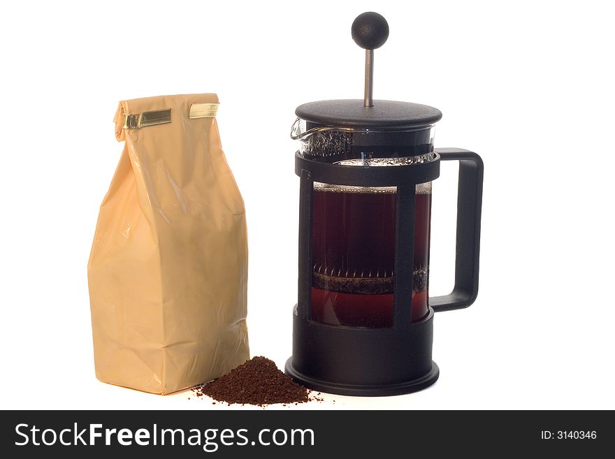 Full french press with a pack of coffee. Full french press with a pack of coffee