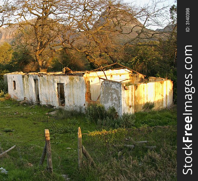 Deserted and derelict farmhouse near Paarl, South Africa in late afternoon sun. Deserted and derelict farmhouse near Paarl, South Africa in late afternoon sun.