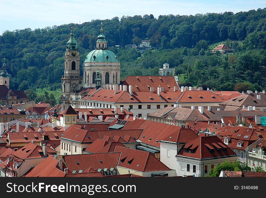 Prague red tile roofs and church