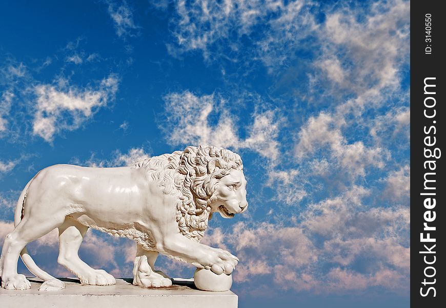 Sculpture of a white lion on a background of the blue sky