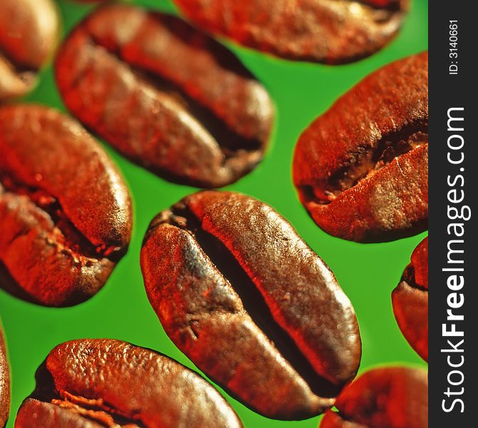 Grains of coffee on a green background