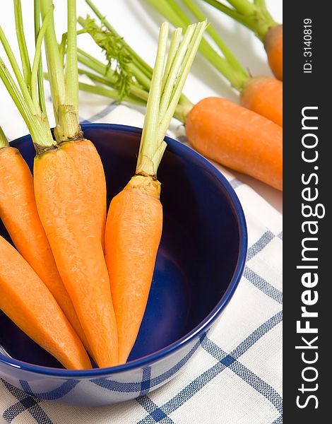 Fresh carrots in the blue bowl