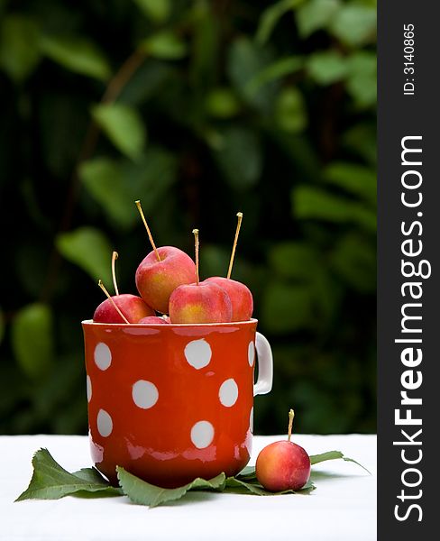 Small red apples in the cup
