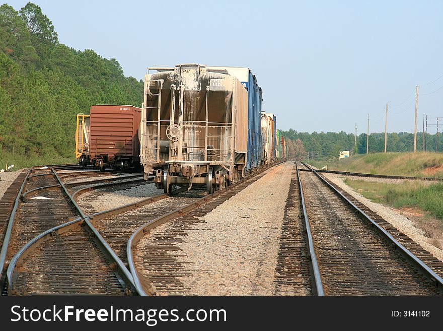 Railroad freight cars sitting at a railroad junction. Railroad freight cars sitting at a railroad junction