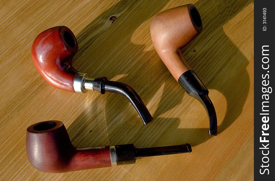 Tobacco pipe. composition on wood