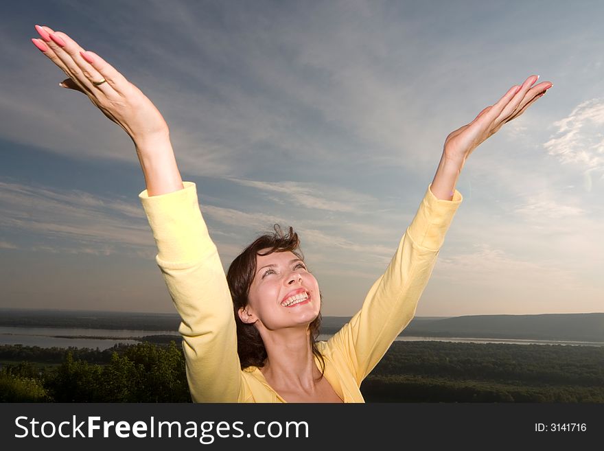 Happy young beautiful girl enjoying the summer evening