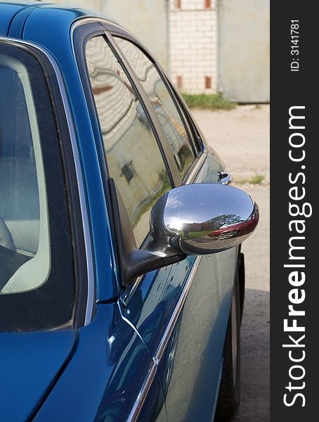 The dark blue machine locate on parking. Reflection from the convex chrome-plated mirror is well visible. The dark blue machine locate on parking. Reflection from the convex chrome-plated mirror is well visible.