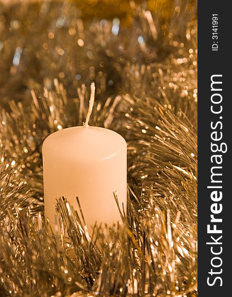 Candle in silver and golden tinsel
