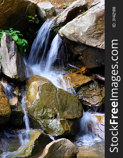 Small waterfall cascading over rocks.