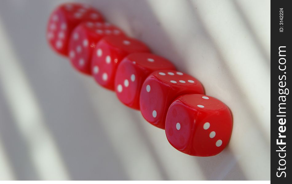 Six red playing dice placed on a table. Six red playing dice placed on a table
