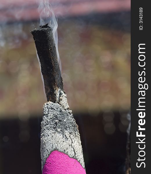 Giant, lit, pink joss stick at a Chinese Buddhist temple. Giant, lit, pink joss stick at a Chinese Buddhist temple