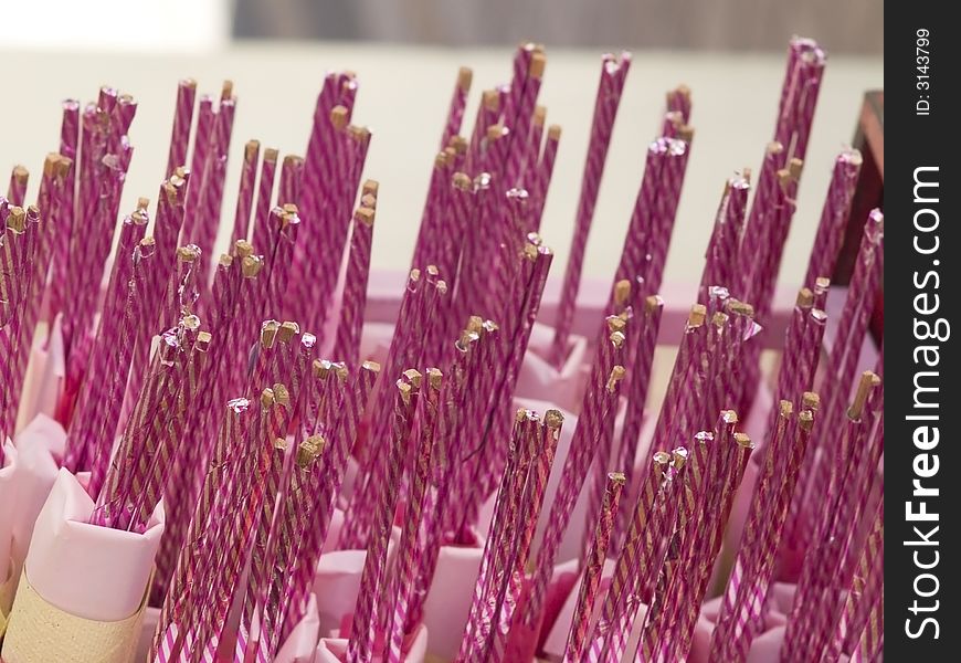 Joss sticks wrapped in pink and silver paper. Joss sticks wrapped in pink and silver paper.