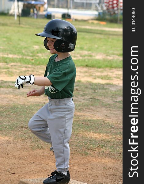 Happy T-ball player on first base. Happy T-ball player on first base.