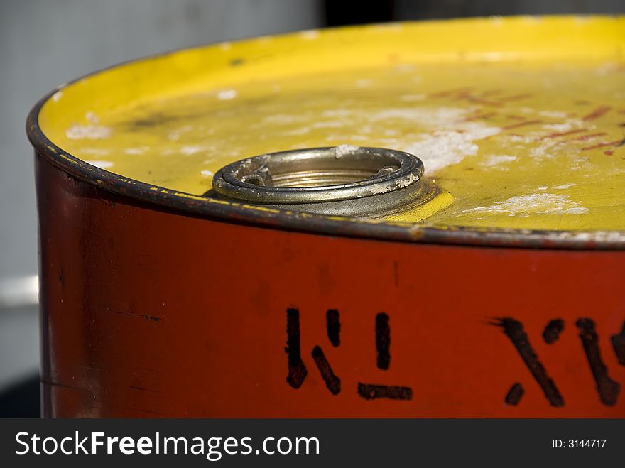 Red and yellow oil ton with some letters on it. Red and yellow oil ton with some letters on it
