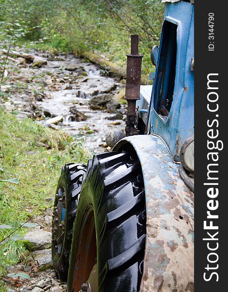 Tractor on the siberian mountain road