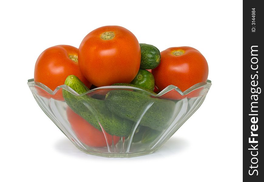 Cucumbers and tomato in bowl, isolated on white background