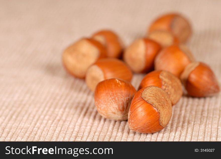 Several fresh whole hazelnuts resting on a table