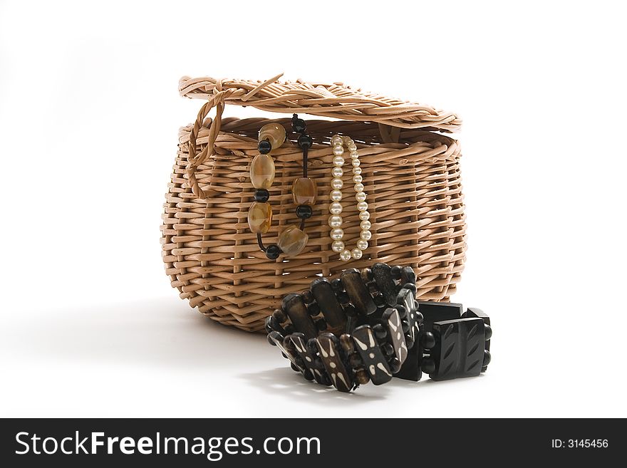 Basket with jewels on white background