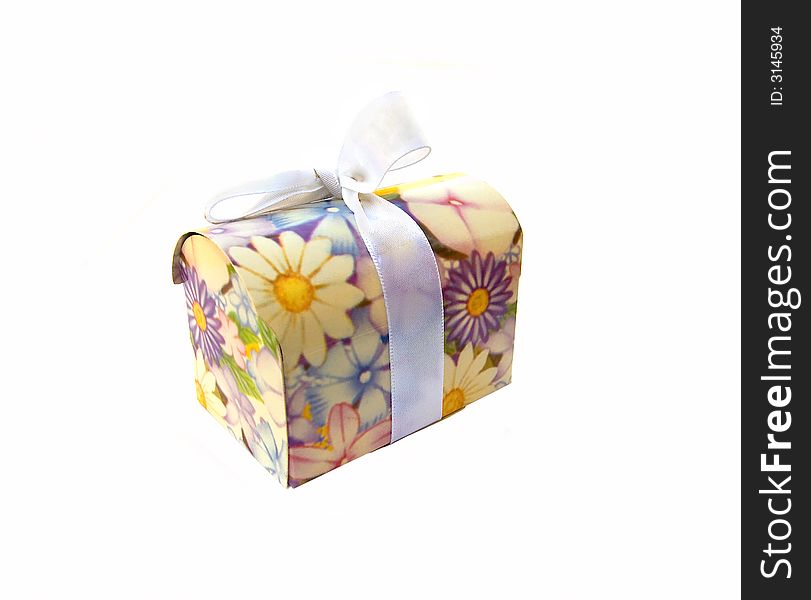 Flower-decorated small gift box with whitish ribbon, over white. Flower-decorated small gift box with whitish ribbon, over white