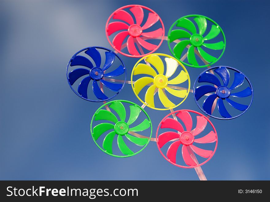 Colorful spinner toy on blue sky backgrouns
