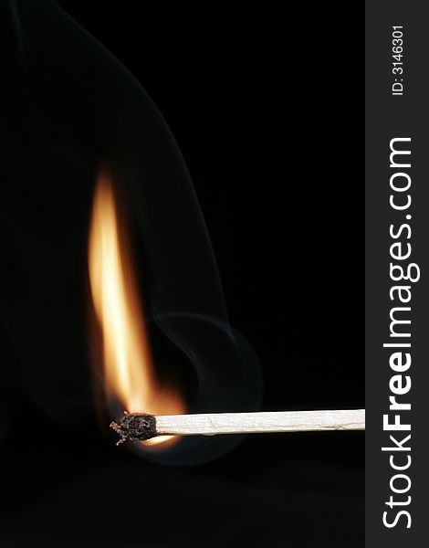 Burning Flame On A Single Matchstick On A Black Background. Burning Flame On A Single Matchstick On A Black Background
