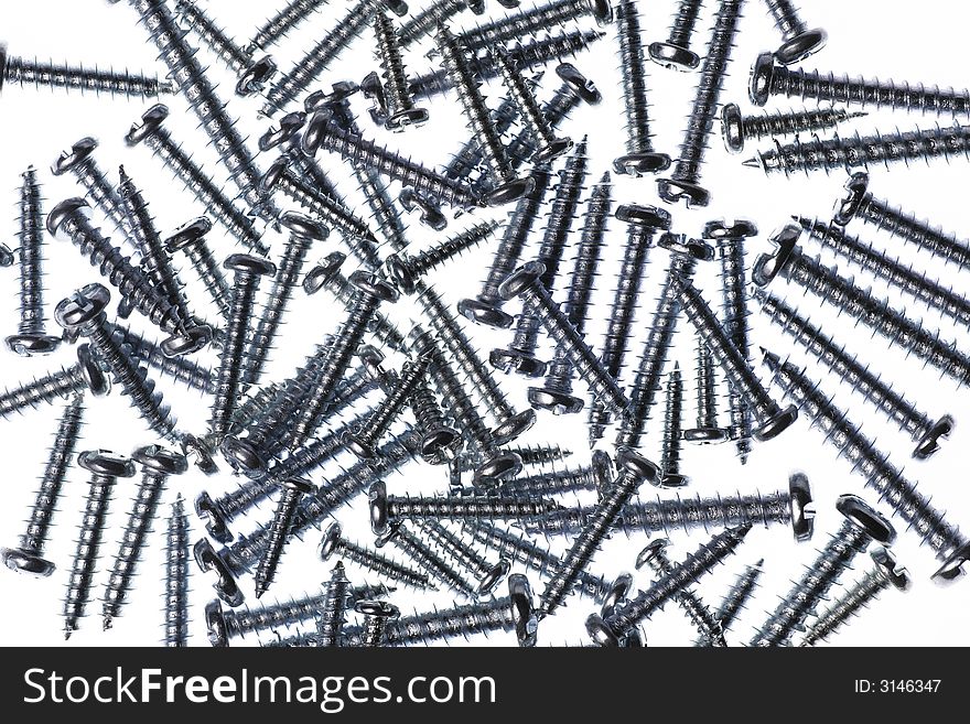 Many Spiral Metal Screws On A White Background