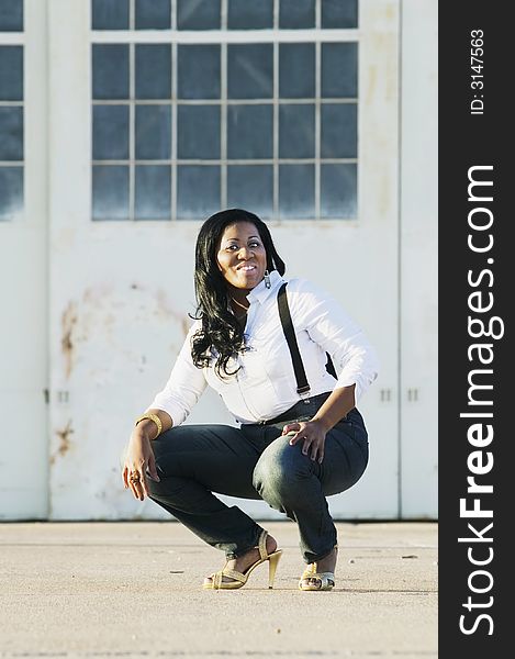 Medium shot of an African American woman at an industrial building.