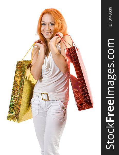 Young girl with shopping bags. Isolate on white background.