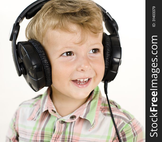 Portrait of little cute boy in earphones isolated