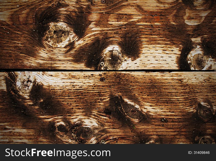 The brown wood texture with natural patterns. The brown wood texture with natural patterns