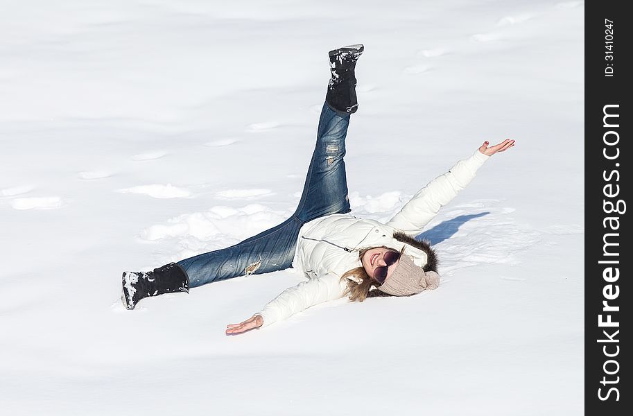 Young woman enjoying winter and playing with snow outdoor