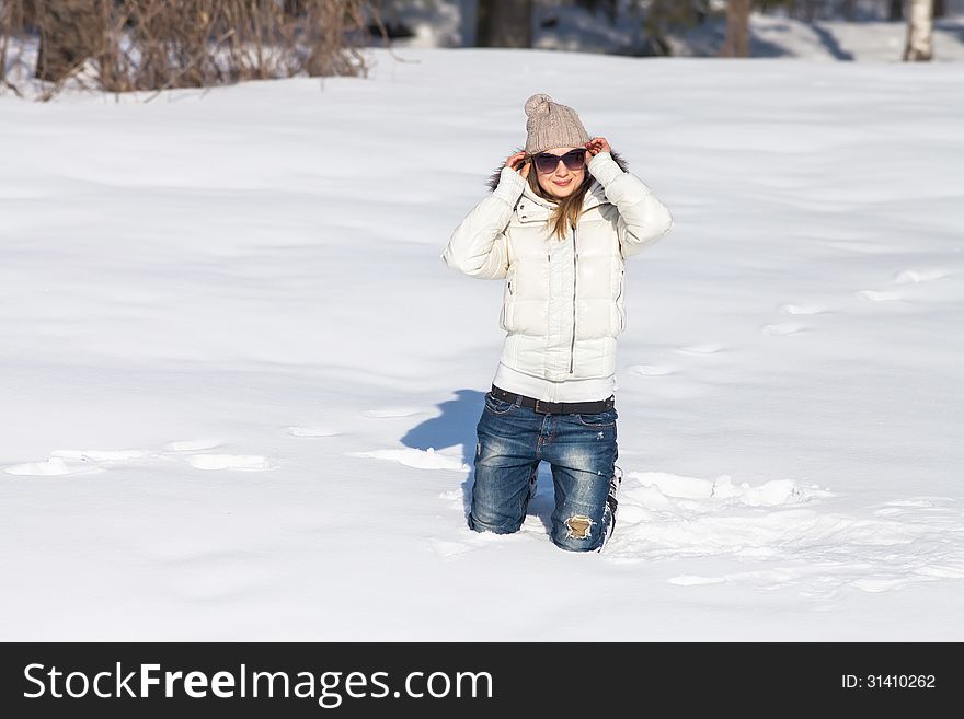 Young woman enjoying winter and playing with snow outdoor