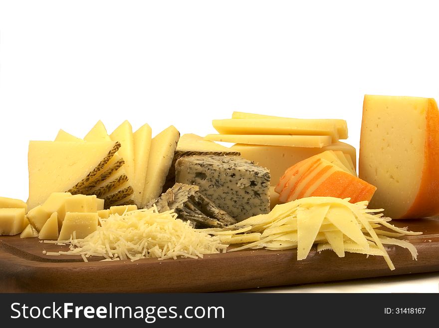A selection of cheeses on a wooden board. A selection of cheeses on a wooden board.
