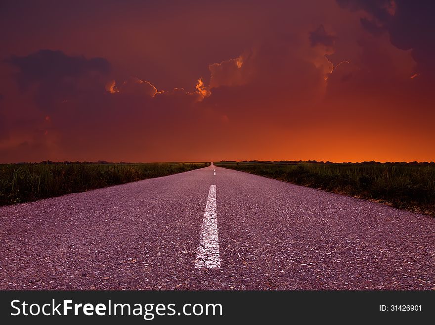 Driving on an empty road at sunset