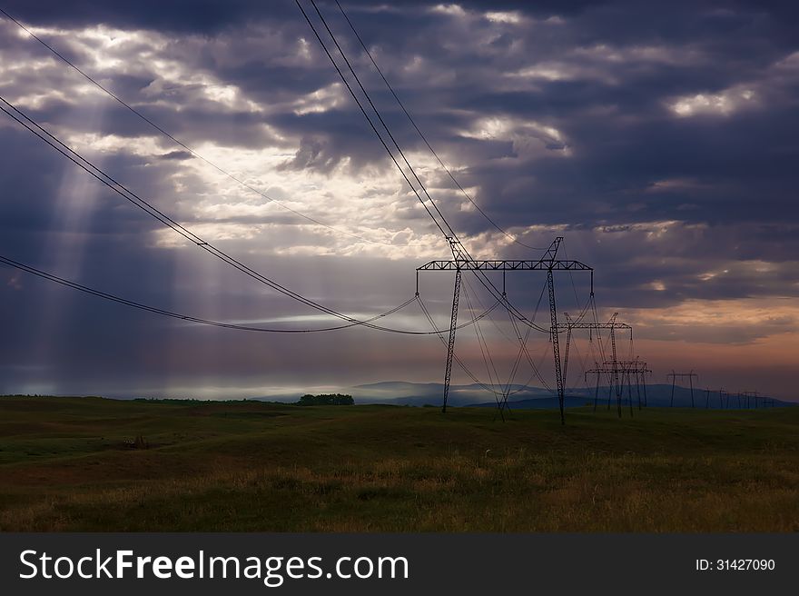 Electricity Pylons At Sunrise.