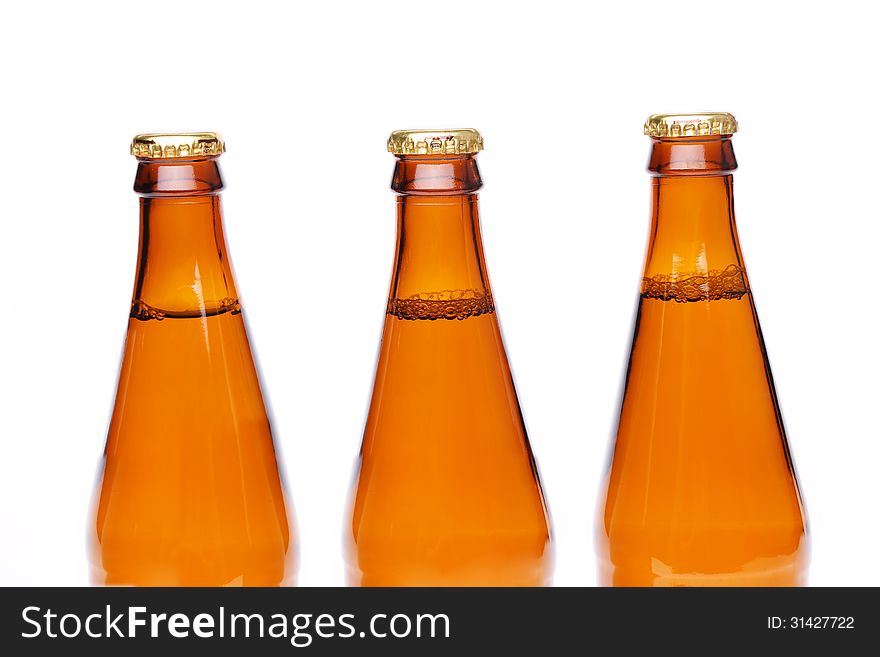 Three brown neck bottles on a white background