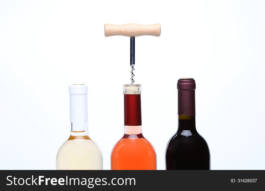 A set of three kinds of wine and corkscrew on a white background