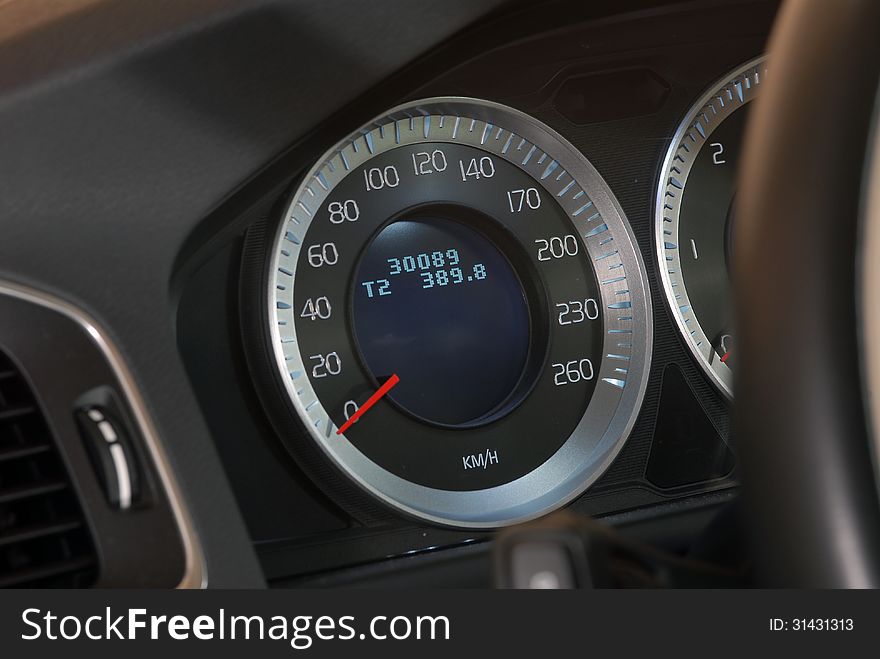 Modern car dashboard closeup, speedometer